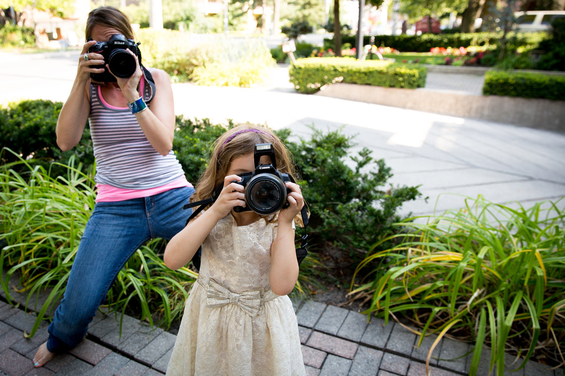 Woman and girl taking photos