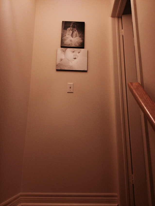 Standout mounted prints outside of bedroom